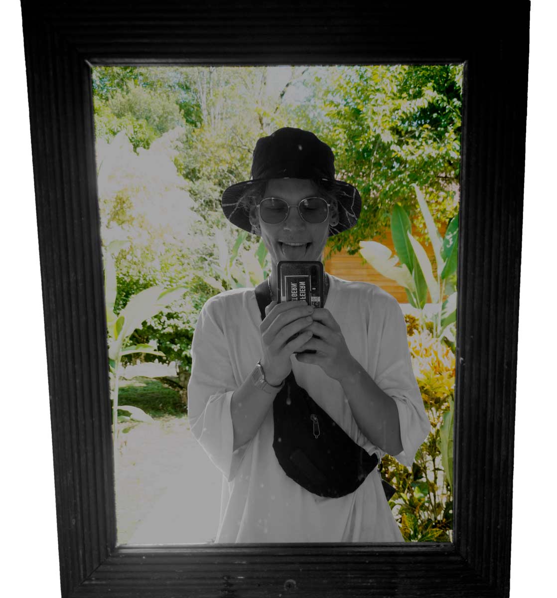 Nodlon photo shot in a mirror with plants in the background.